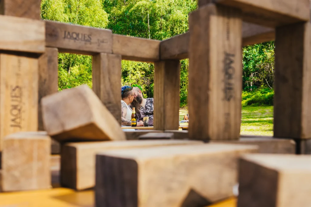 Couple kissing, framed through giant Jenga blocks