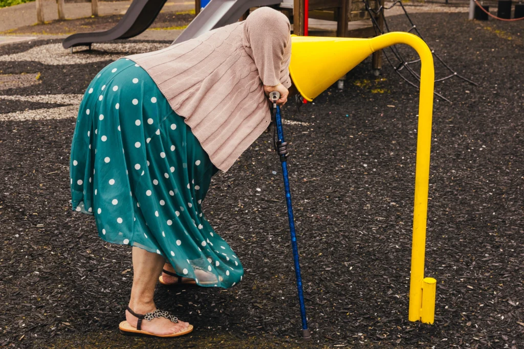 Wedding guest with her head in a yellow playground listening funnel