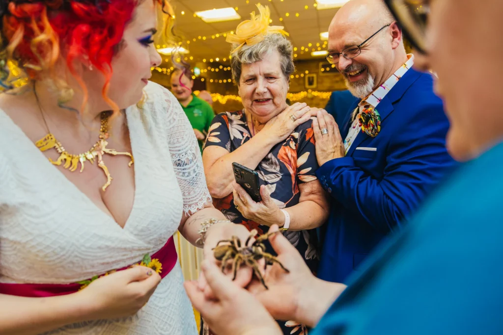 Bride holding a tarantula as her nan and dad react