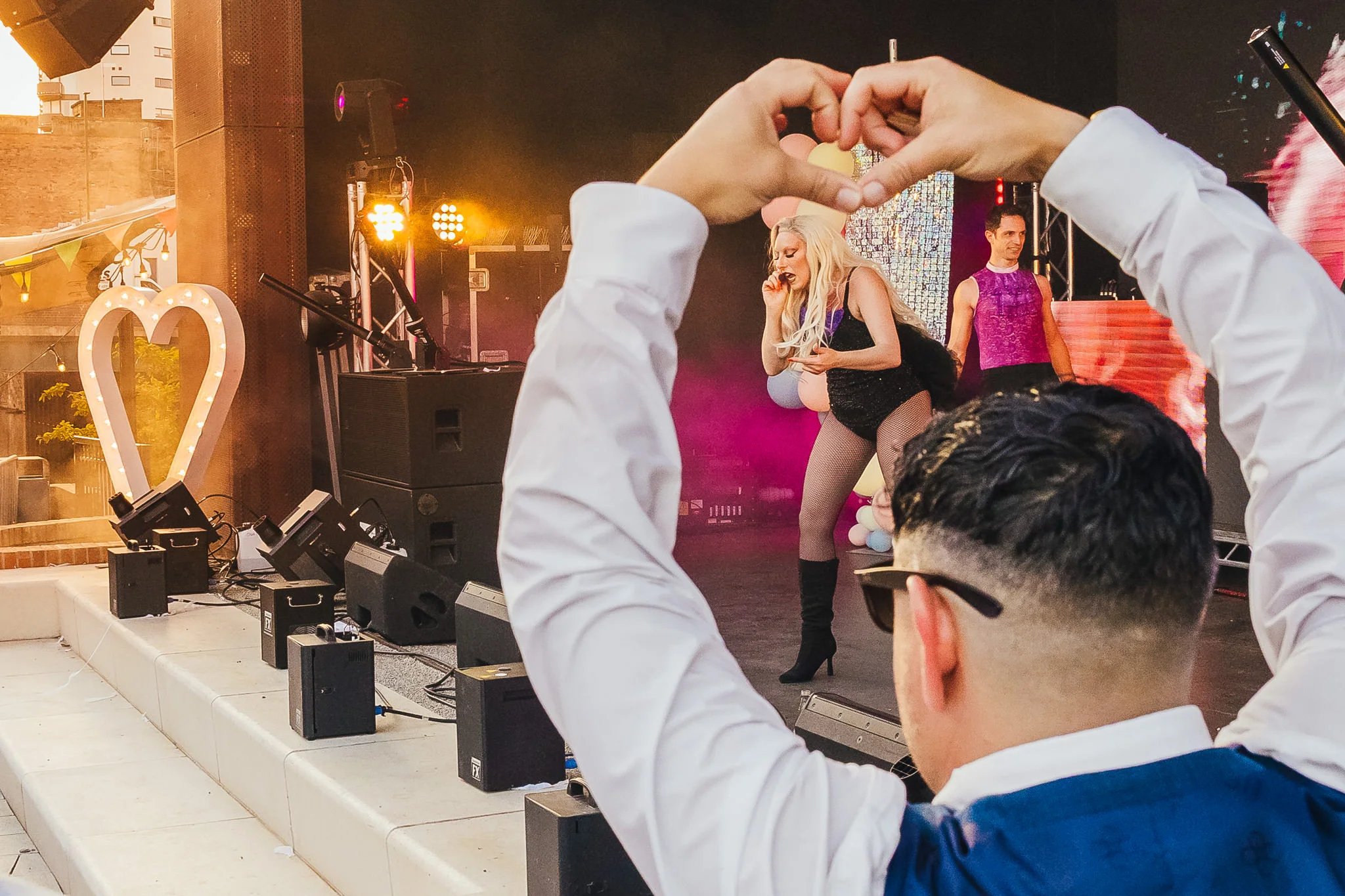 Guest making a heart with her hands for the band at Binks Yard