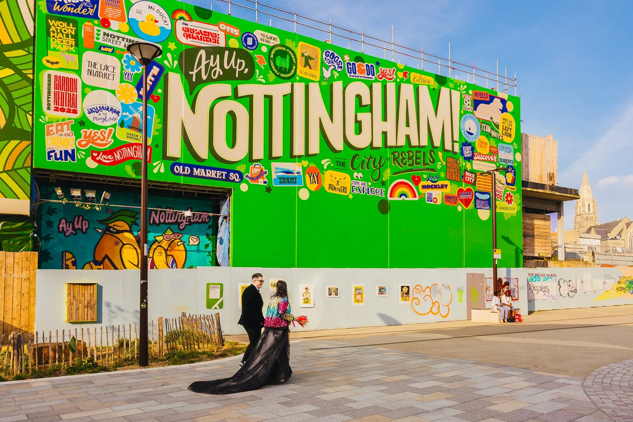 Couple by the giant Ay Up Nottingham sign