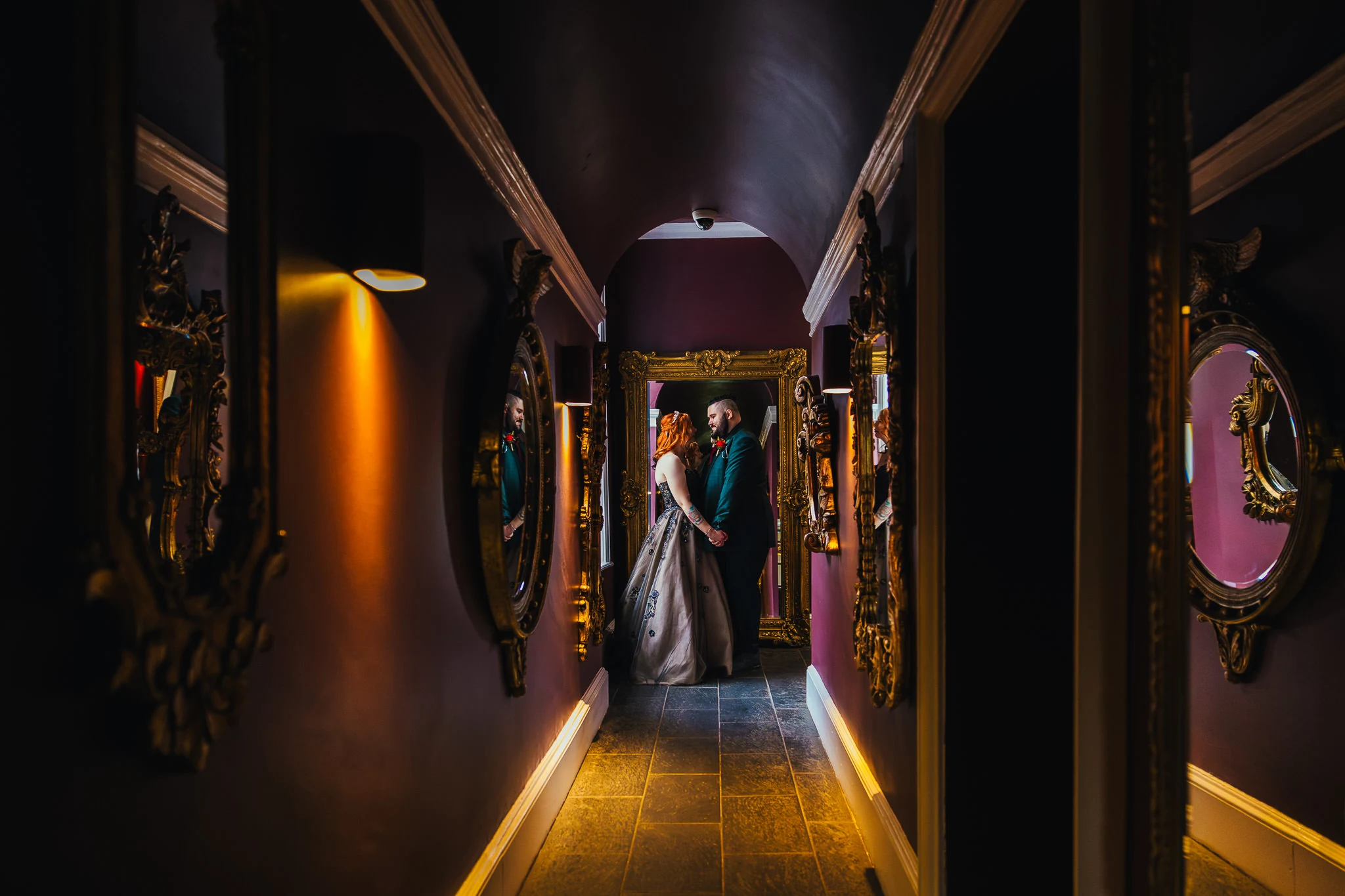 Couple in a candlelit corridor at Colwick Hall