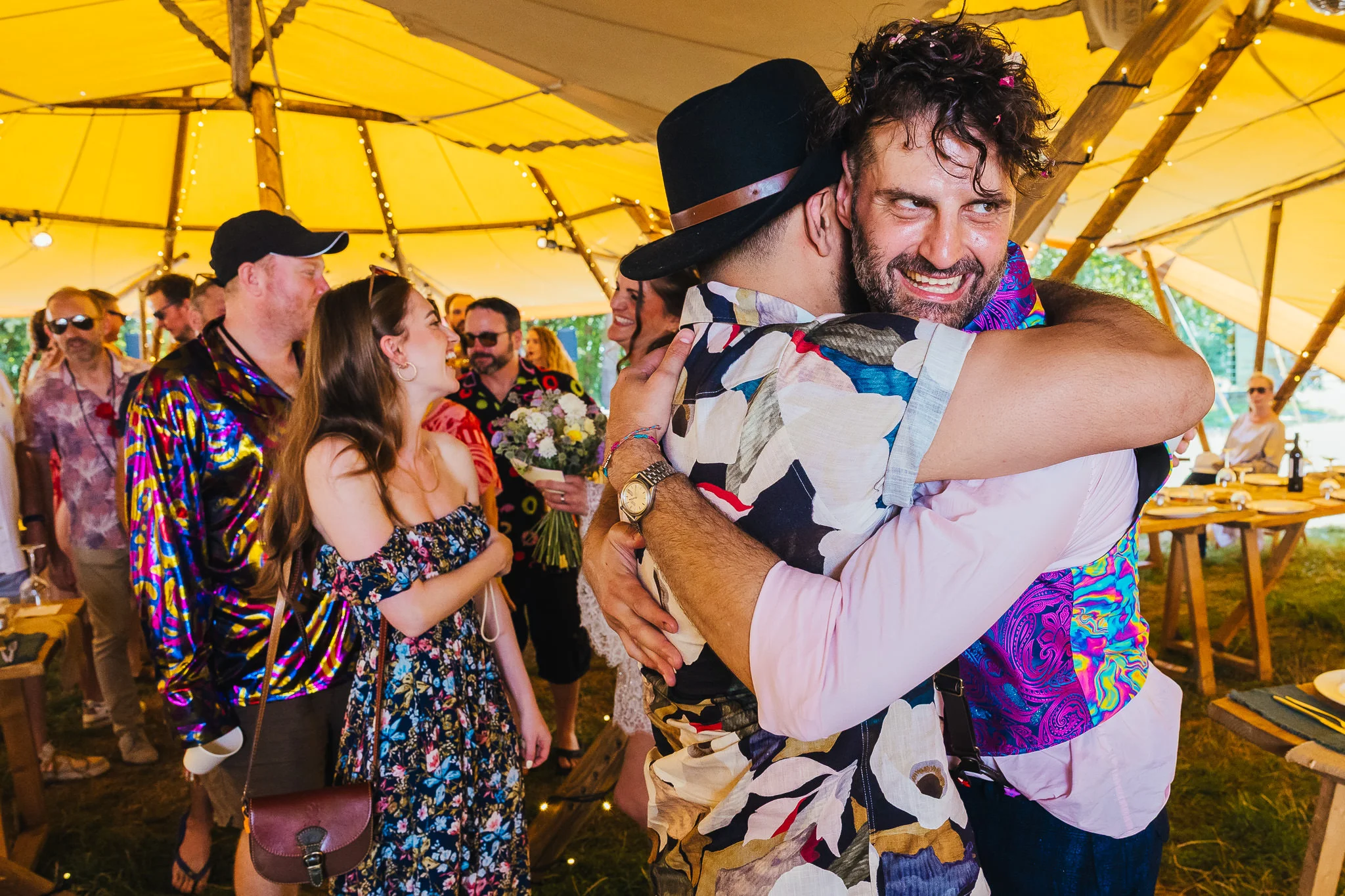 Guests hugging at a festival wedding