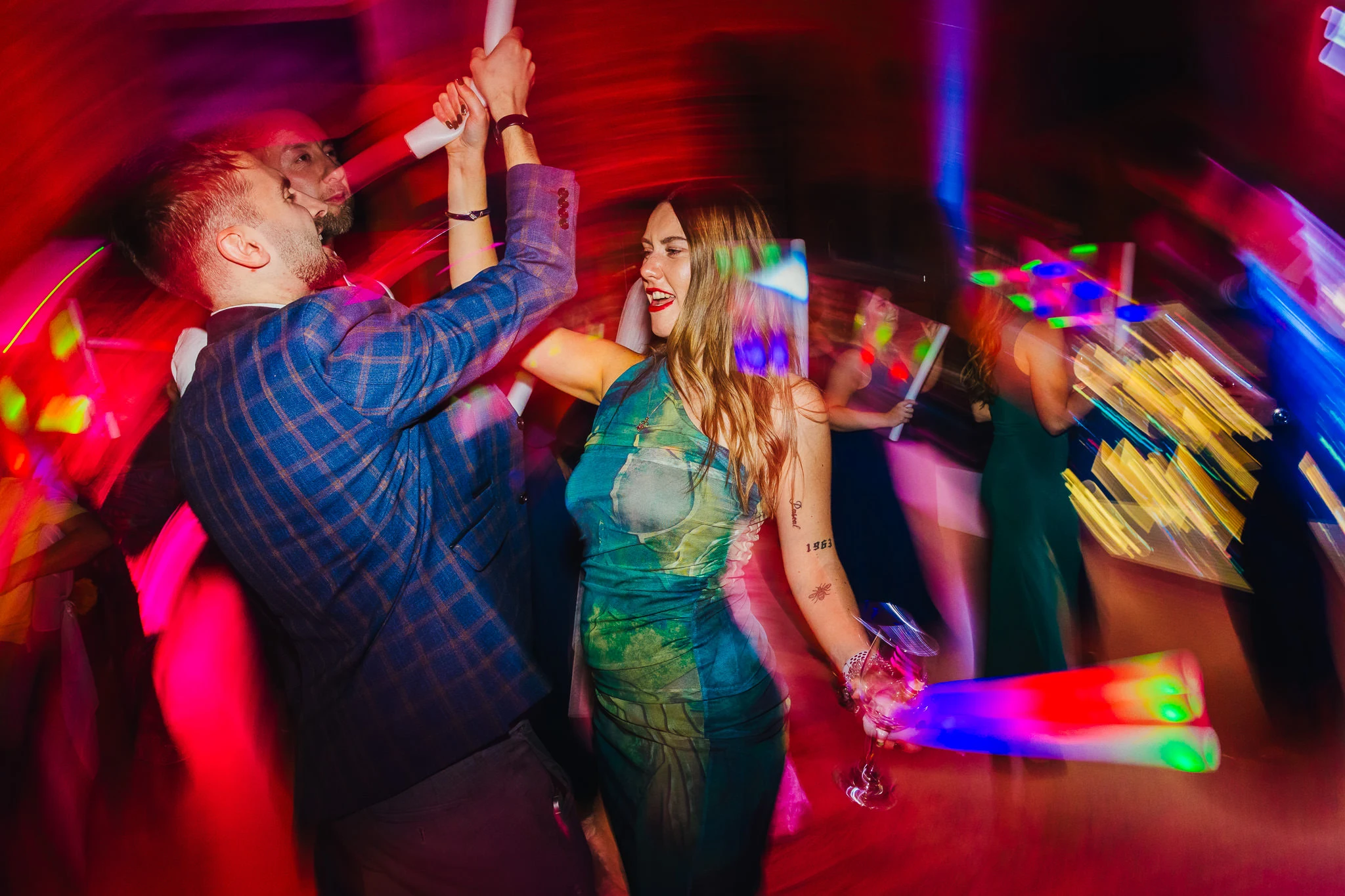 Guests dancing under coloured lights at Carriage Hall