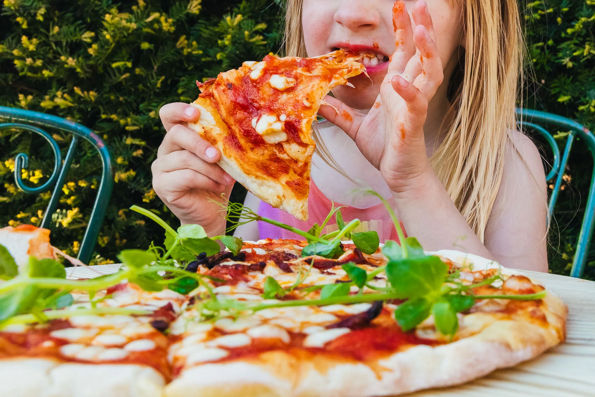 Young guest eating pizza at a wedding
